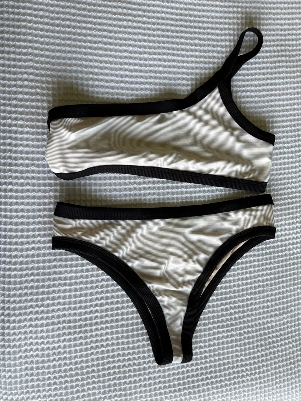 White one shoulder bikini with black lining